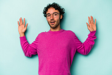 Young caucasian man isolated on white background being shocked due to an imminent danger