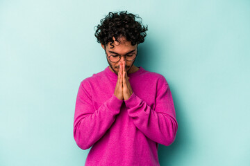 Young caucasian man isolated on white background praying, showing devotion, religious person...