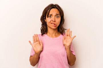 Young hispanic woman isolated on white background rejecting someone showing a gesture of disgust.