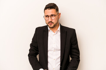 Business hispanic man isolated on white background confused, feels doubtful and unsure.