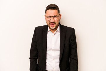 Business hispanic man isolated on white background screaming very angry and aggressive.