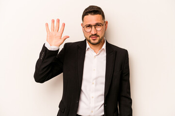 Business hispanic man isolated on white background smiling cheerful showing number five with fingers.