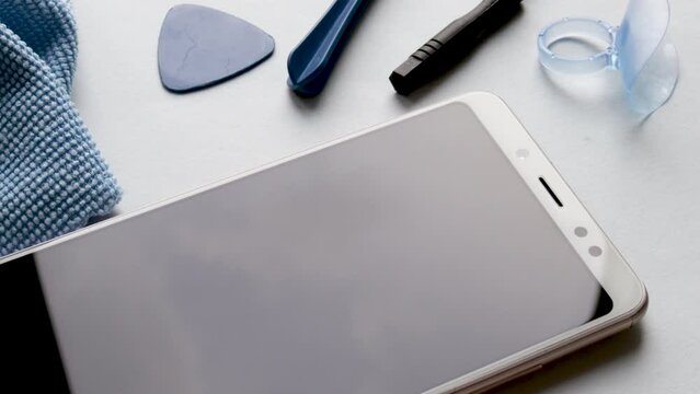 maintenance and repairing smartphones. spin on table many tempered glass screen protectors and mobile phone, replace concept. mobile screen replacement protector,repair kit. installation of protective