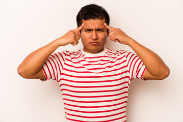 Obraz premium Young hispanic man isolated on white background focused on a task, keeping forefingers pointing head.