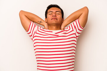 Young hispanic man isolated on white background feeling confident, with hands behind the head.