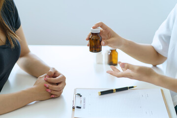 Female doctor asks about the patient's condition and makes recommendations about medications and...