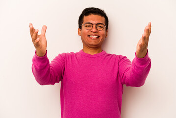 Fototapeta premium Young hispanic man isolated on white background celebrating a victory or success, he is surprised and shocked.