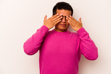 Young hispanic man isolated on white background afraid covering eyes with hands.
