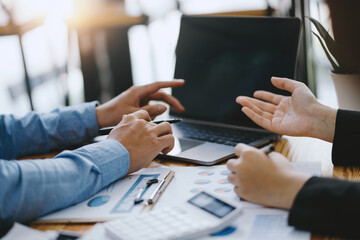 Business people discuss investment project working and planning strategy on laptop computer.