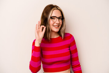 Young caucasian woman isolated on white background cheerful and confident showing ok gesture.