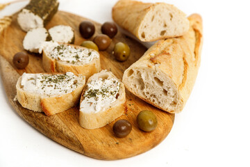 Bread, cottage cheese and olives on wooden board. Jewish holiday Shavuot concept. Top view