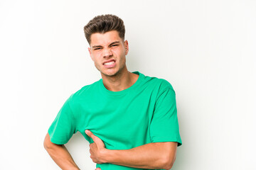 Fototapeta premium Young caucasian man isolated on white background having a liver pain, stomach ache.