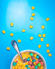 Colorful cereal on isolated blue background