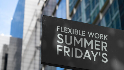 Flexible Work Summer Fridays on a black city-center sign in front of a modern office building	