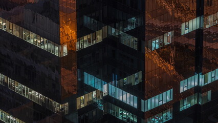 Windows in office building exterior in the late night with interior lights on timelapse - Powered by Adobe