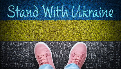 Person Standing With Ukraine on Asphalt With Painted Flag and Stop War Word Cloud
