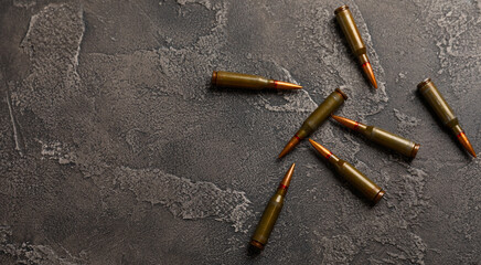 Bullets on black textured marble. Bullets of a kolashnikov assault rifle close-up with space for...