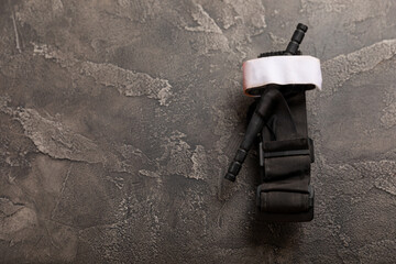 Medical tourniquet to stop the blood on a black textured wood. Place to copy. view from above. flat...
