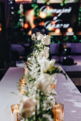 tableware Glasses, flower fork, knife served for dinner in restaurant with cozy interior