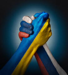 Symbol. Relations between Ukraine and Russia. Flag of the two countries on hands. - 505004693
