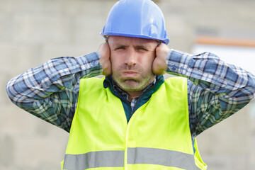 construction suffering from noise pollution on building site - obrazy, fototapety, plakaty
