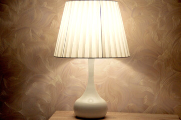 Modern interior. Empire style floor lamp stands on the nightstand in the bedroom