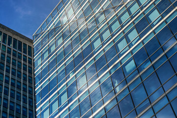 Fototapeta na wymiar Windows on modern glass and steel skyscraper building - abstract business background