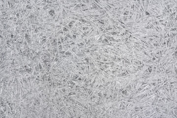Ice on frozen river forming crystal like structures, closeup macro detail from above - abstract winter background
