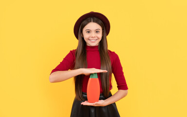 daily habits and personal care. advertisement. happy girl in hat hold shampoo.