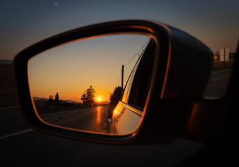 sunset in the rear-view mirror
