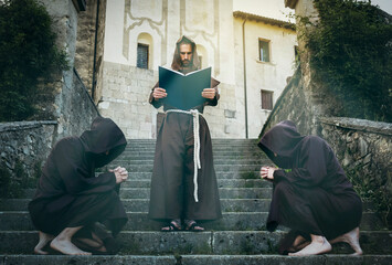 Templar monk reads the sacred scriptures to his monk brothers.