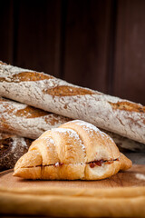 Croissant with filling. Croissant with chicken, salad, and cheese. Breakfast. French croissant