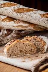 Fresh bun, sliced bun. Bread on a brown background. Rural food. Homemade pastries