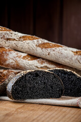 Black burger with grilled chicken. American burger. Brown burger with cuttlefish ink. Photo of a burger