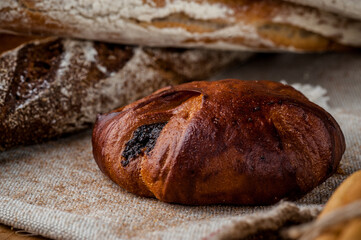 Fresh bun, sliced bun. Bread on a brown background. Rural food. Homemade pastries