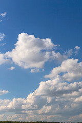 Naklejka na ściany i meble Beautiful blue sky with white cumulus clouds as natural background