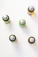 Set of plastic bottles for cosmetic products. White background with shadows. Travel kit.