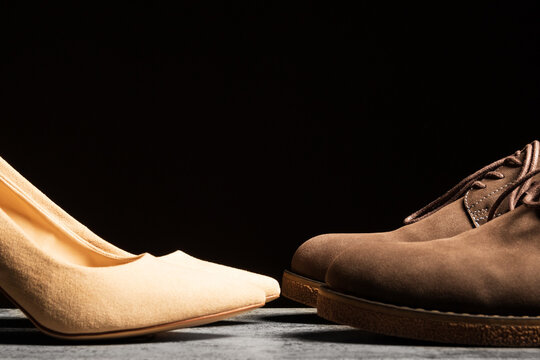 Women's and men's shoes opposite each other. The concept of relationships and equality in the family.