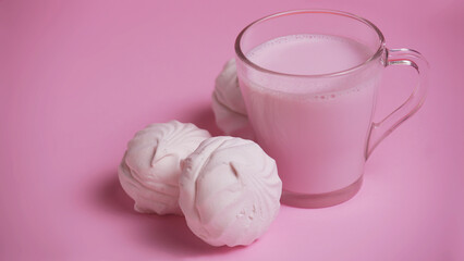 Fototapeta na wymiar milk drink and marshmallows on a pink background