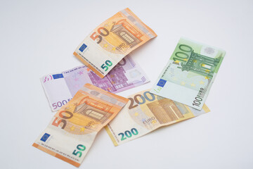 fifty euro banknotes, on five hundred and two hundred euro banknotes, and on the latter a one hundred euro banknote; forming a beautiful harmony of colors which can be used for any financial, economic
