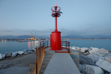 Red lighthouse of the port in Marina di Carrara, Tuscany, Italy. - 505019089