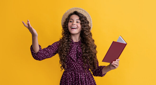 positive child with frizz hair recite book on yellow background