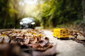 Yellow school bus toy model on country road.Back to school and Education concept background.