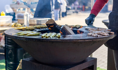 Smelt fish is fried on a large grill during the fish festival in Svetlogorsk Raushen, Kalinigrad region, Russia, near the Baltic sea. 