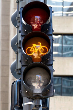 Bicycle Light Yellow for Cyclists in City Street. Yellow bike light in an urban cyclist road lane. Urban bicycle ridding signaling caution. Cyclist traffic light for bicycle people.  