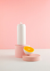 White colored can with cut in half orange fruit on product podium. Summer drink minimal concept.