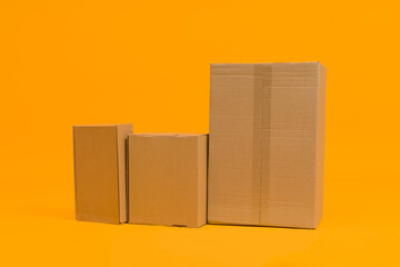 cardboard boxes on yellow background, delivery or moving concept