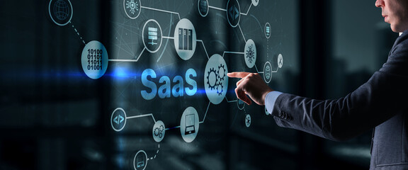 SaaS Software as a Service concept with man hand pressing text