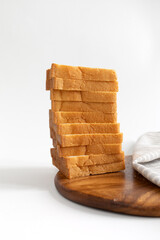stack of toast bread on wooden board with napkin
