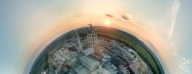 Aerial view from high altitude of little planet earth with cement factory tower with high concrete...
